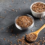 Flax seeds linseed superfood healthy organic food concept on dark background with copy space