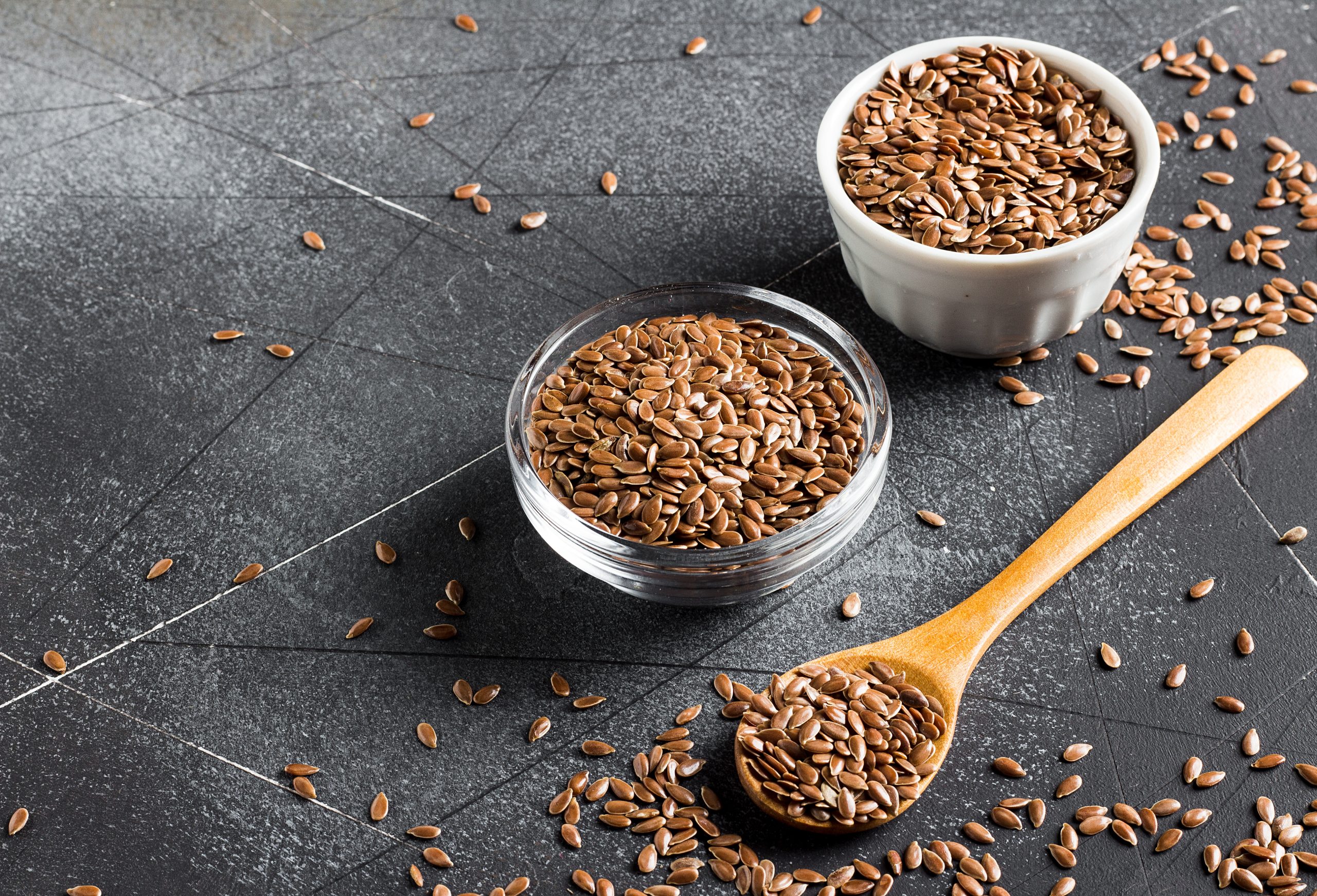 Flax seeds linseed superfood healthy organic food concept on dark background with copy space